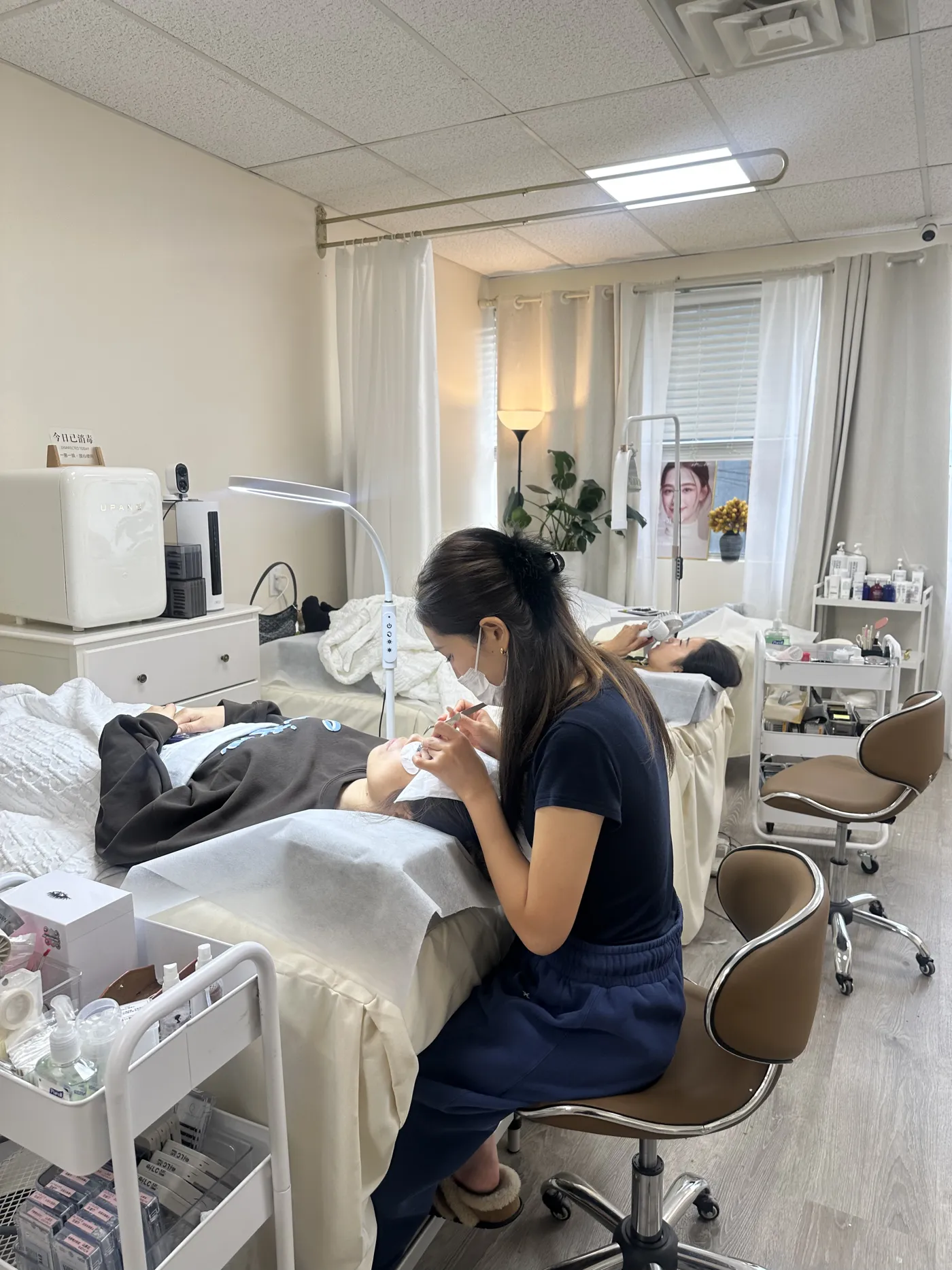 COCO Beauty lash artist applying lash extensions to a client
